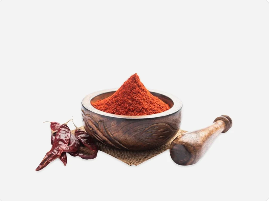 Kashmiri red chilli powder in a carved spice bowl